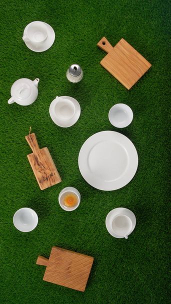 Dishes on the lawn. Dishes on a green background. Picnic concept. Copy space top view. - Valokuva, kuva