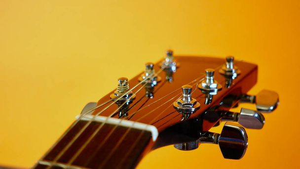 guitar headstock closeup . yellow background - 写真・画像