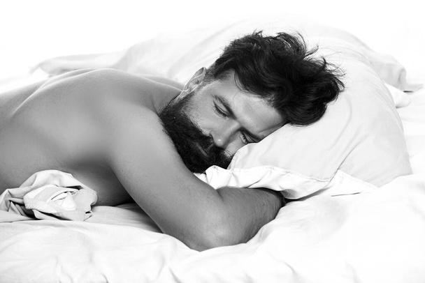 Man in bed. Young man sleeping on bed. Handsome man sleeping in bed. Need some rest. - Foto, afbeelding
