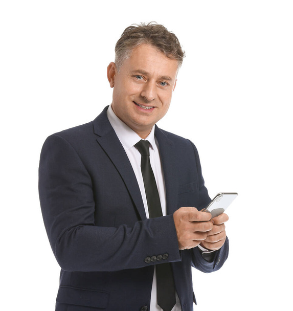 Mature businessman with mobile phone on white background - Valokuva, kuva