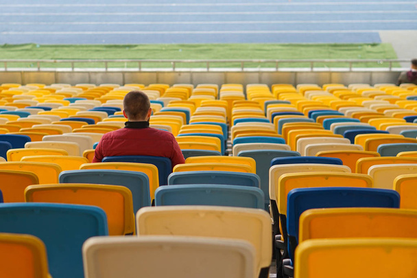 spectators watch football in a half-empty stadium - Valokuva, kuva
