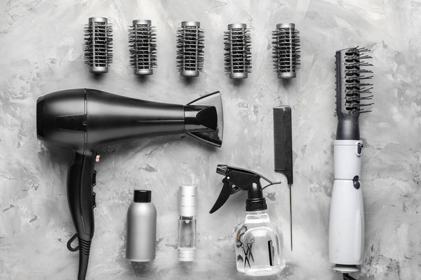 Modern hairdresser tools on grey background - 写真・画像