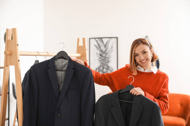 Female stylist with male clothes in her studio - Foto, Imagem