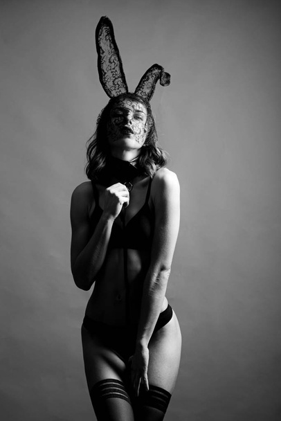 Happy Valentines Day. Brunette posing nude wearing bunny ears. Female with sexy ass posing wearing bunny ears on Easter day. Cute bunny. Expression face. - Valokuva, kuva