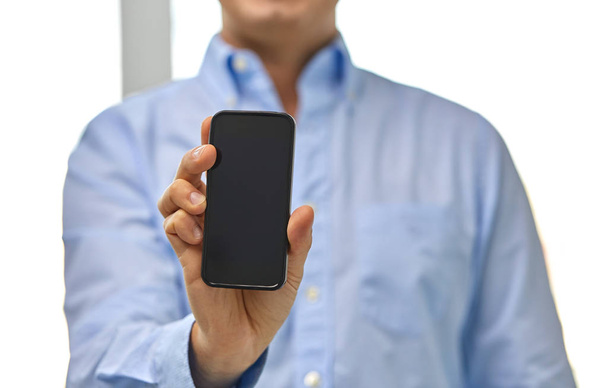 businessman showing smartphone screen - Fotó, kép