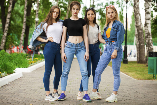 Close up - Four schoolgirls posing in summer park - Photo, Image