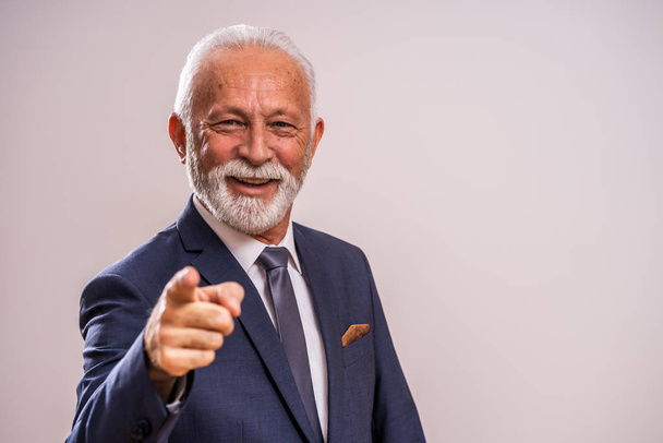 Portrait of happy senior businessman who is pointing at you. - Foto, afbeelding