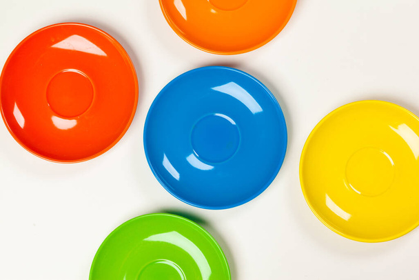 Colorful saucers on a vibrant bright background - Valokuva, kuva