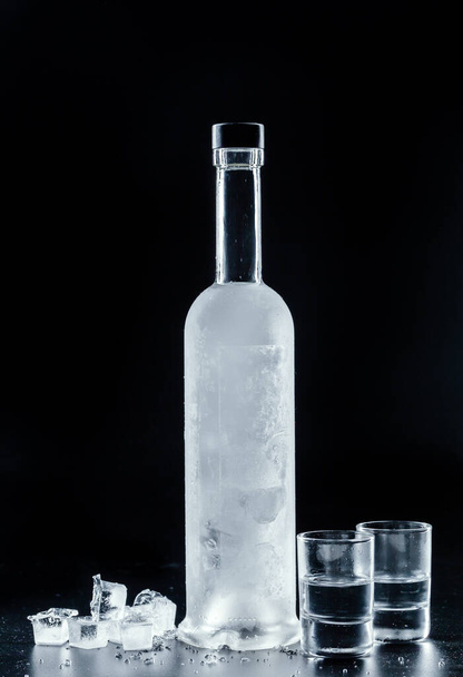 Bottle of cold vodka on dark background - Photo, Image
