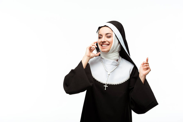 beautiful happy nun talking on smartphone isolated on white - Foto, Imagem
