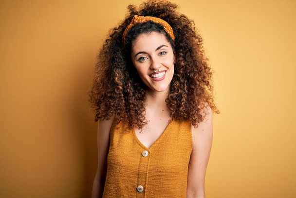 Young beautiful woman with curly hair and piercing  - 写真・画像