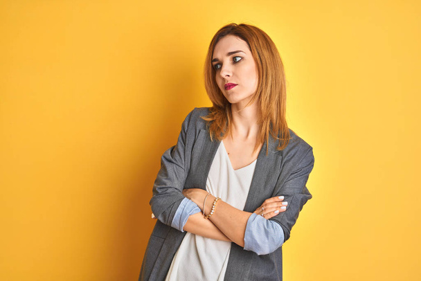 Redhead caucasian business woman over yellow isolated background looking sleepy and tired, exhausted for fatigue and hangover, lazy eyes in the morning. - Photo, Image
