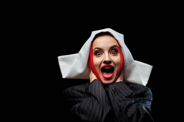 excited demonic nun with red eyes shouting isolated on black - Photo, Image