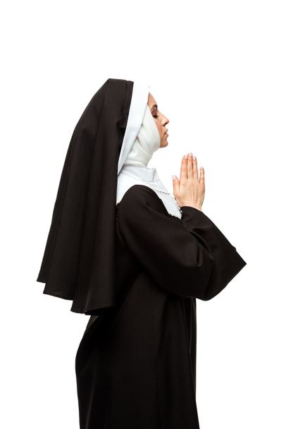 beautiful nun praying with closed eyes and hands together isolated on white - Valokuva, kuva