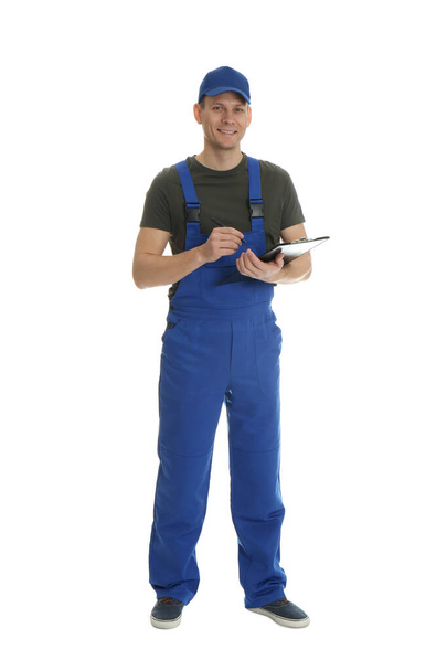 Full length portrait of professional auto mechanic with clipboard on white background - Фото, зображення