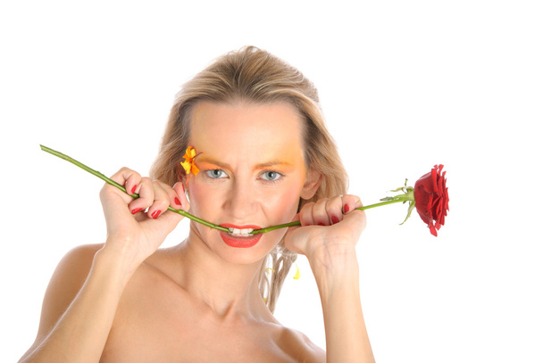 Young woman bites flower stalk - Valokuva, kuva