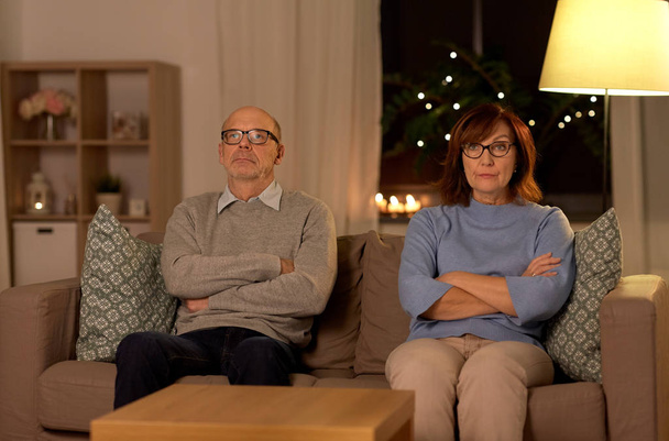 unhappy senior couple sitting on sofa at home - Foto, Bild