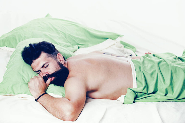Bored sleepless and tired in bed. Man sleep in bed alone. Happy to Sleep. Sleep disorders concept. Guy lying in bed try to relax and fall sleep. - Φωτογραφία, εικόνα