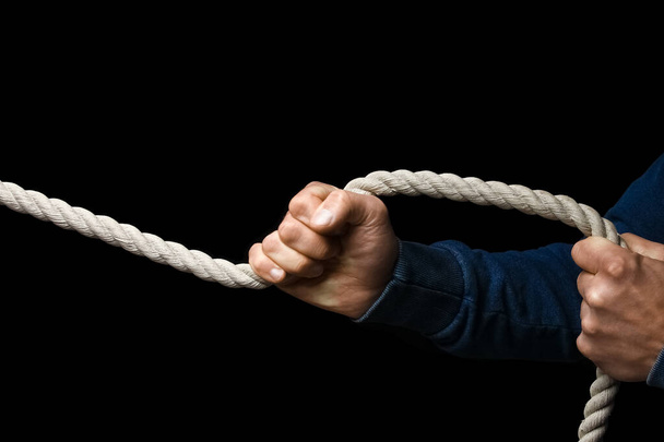 hands with a rope on a black background - Zdjęcie, obraz