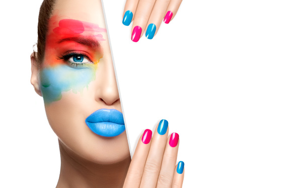High fashion model with colored eye makeup, perfect skin, blue glossy lips and colorful nails, half face with a white card template. Fashionable advertisement concept for makeup and cosmetics - Photo, Image