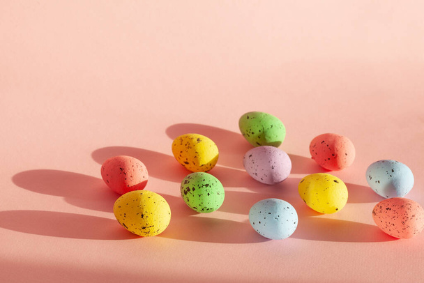Multicolored Eggs with morning sunlight. Colorful Compositions on pink background. Concept easter. - Zdjęcie, obraz
