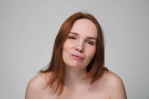 woman with red hair, freckles on white background - Zdjęcie, obraz