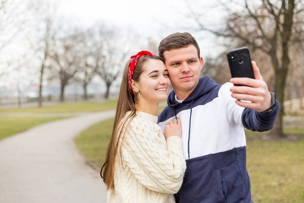 Milující veselý šťastný pár, který bere selfie do města. Zachytit spolu šťastné chvíle. Hezký muž dělat selfie se svou krásnou ženou. - Fotografie, Obrázek