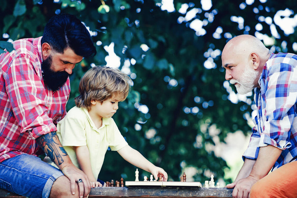Happy family. Like chess game. I love chess. Healthy lifestyle concept. Cute boy developing chess strategy. Senior man workout in rehabilitation center. - Foto, afbeelding