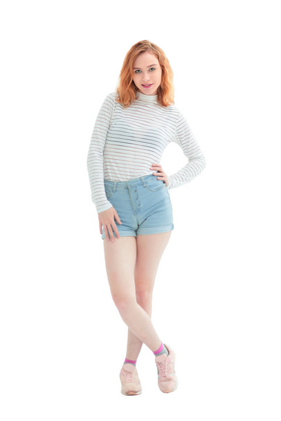 in full growth. confident model girl in jeans shorts - Фото, изображение