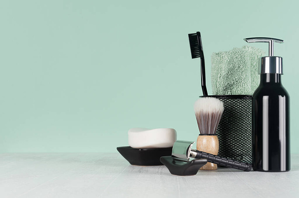 Fashion men toiletry accessories in black color in green mint menthe and white interior - razor, toothbrush, towel, soap, dispenser. - Fotó, kép