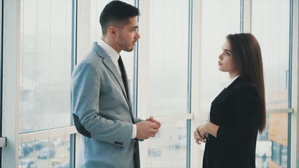 Two business people are talking in office, on the panoramaic blurred background. Close up. Copy space. 4K. - Filmagem, Vídeo