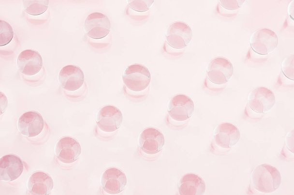 Abstract gentle pink background -  transparent glass balls as pattern on pastel color, top view. - Photo, Image