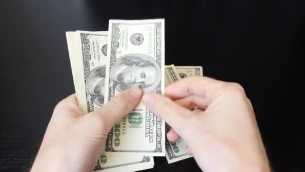 One hundred dollar paper money pile on office desk. Male counting money cash. Close up of american dollar bills. Dollars in hand. American currency exchange in bank - Filmati, video