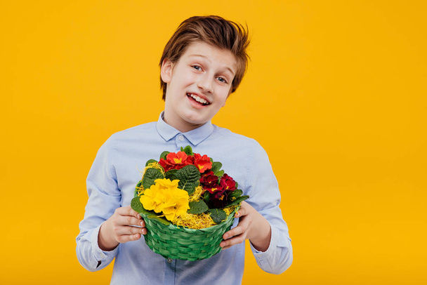 happy boy with basket of flowers in his hand - Фото, изображение