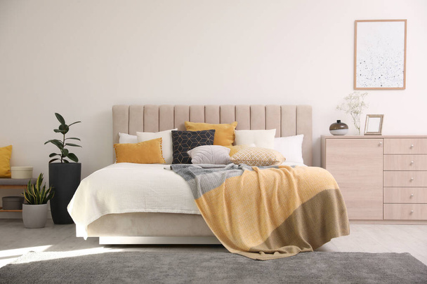 Stylish interior of contemporary room with comfortable bed - Фото, изображение