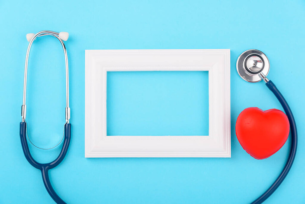 Doctor's Day concept, flat lay top view, stethoscope with photo frame diagnosis of heart disease on blue background with copy space for text - Fotoğraf, Görsel