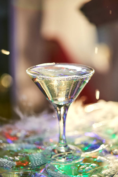 copos martini na forma de uma cascata ou pirâmide iluminada luz na festa de casamento
 - Foto, Imagem