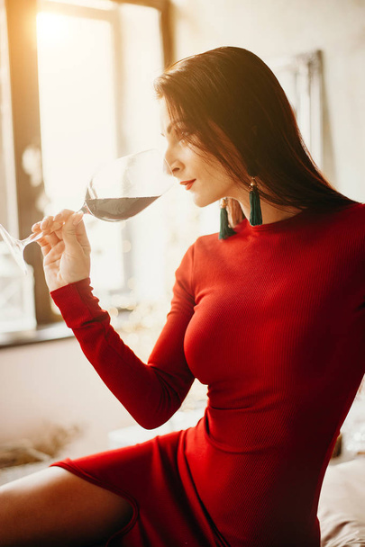 Woman in red dress with glass of red vine - Zdjęcie, obraz