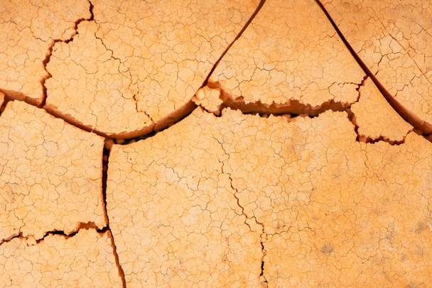Close up of crack soil and muddy in the dry season textures, hot summer. Patterns and texture cracked soil of sunny dried earth soil, Drought of the ground. Dried cracked earth soil ground background - Photo, Image