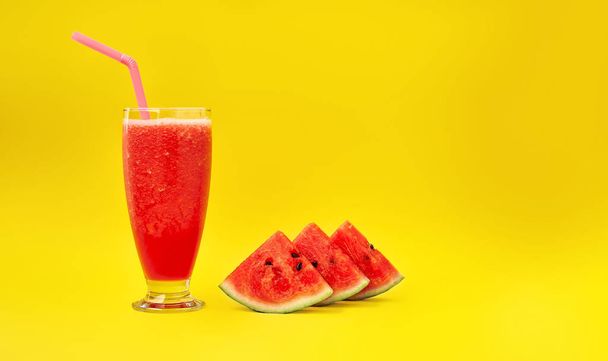 Watermelon smoothie and three slices of watermelon on a yellow background. Minimal style. Space for text - Foto, Bild