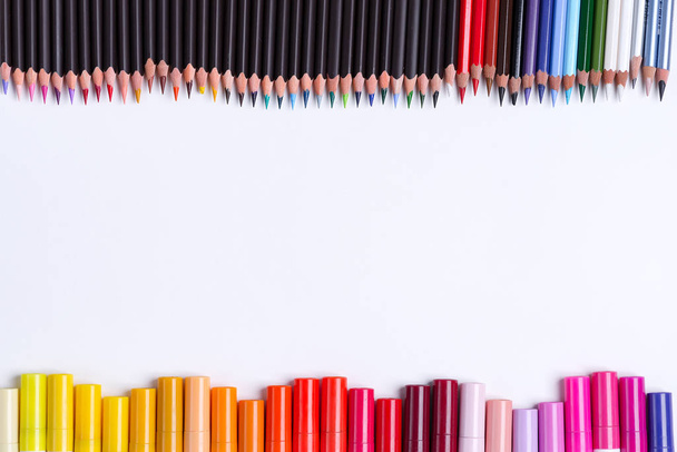 Painting multicolored border from colorful markers and pencils for art creativity on a white background. Flat lay - Photo, Image