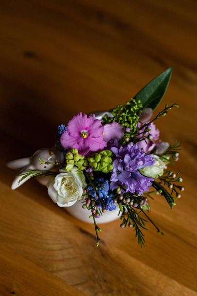 イースターウサギの置物が飾られたお鍋に美しい多色の花束が立っています - 写真・画像