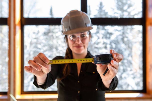 worker woman holding a tape measure - Photo, Image
