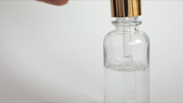 Dropper glass Bottle Mock-Up wth hyaluronic acid on white background, beauty serum - Filmati, video