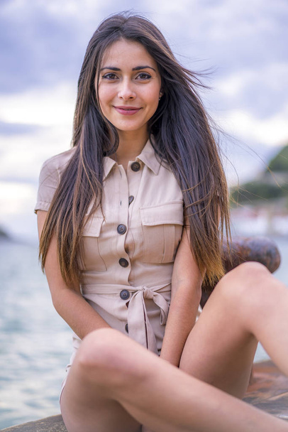 fashion portrait of attractive young woman at pier of San Sebastian, Spain - Fotó, kép