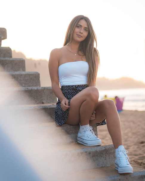 fashion portrait of attractive young woman at stairs at beach of Zarautz - Valokuva, kuva