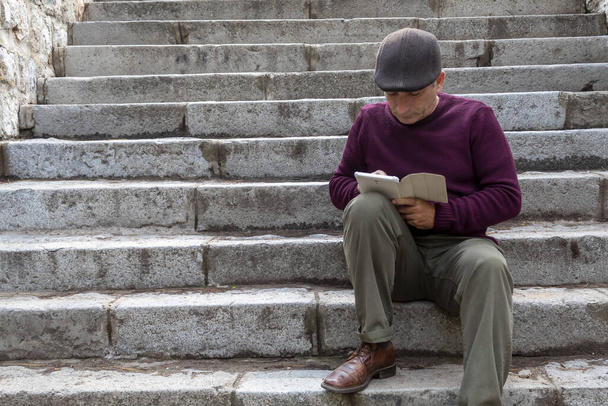 Middle Age Men Sitting on Stone Stairs and Playing With Tablet - Photo, Image