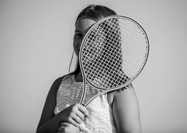 Energy inside. game playing. summer outdoor games. play tennis. childhood happiness. healthy lifestyle. small girl with tennis racquet. summer sport activity. energetic child. happy and cheerful - Foto, Bild