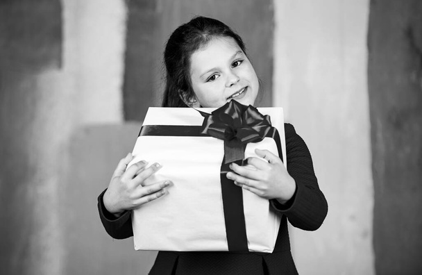 Happy holiday. big christmas sale. kid hold gift box. boxing day concept. dreams come true. happy new year. winter holiday and xmas joy. seasonal shopping discount. little girl carry present - Фото, изображение