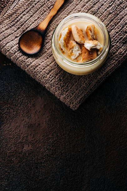 Vanilla custard with homemade cookie on wooden table. Top view. Copyspace - 写真・画像